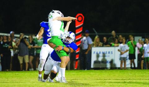 Levi Rivera puts a hit on the Burnet quarterback during last week’s district opener. HUNTER KING | DISPATCH RECORD