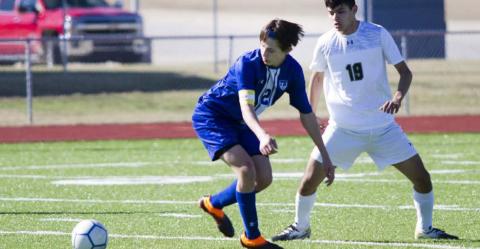 Senior striker Cody Woods (2) races a Canyon Lake Hawk to the ball on Saturday. JEFF LOWE | DISPATCH RECORD
