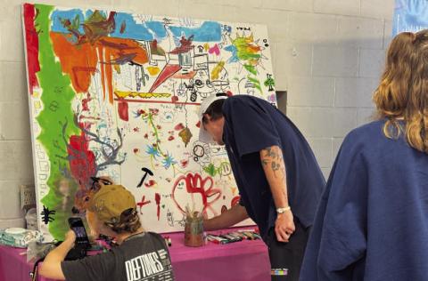 ADAM BARRIOS | DISPATCH RECORD Community members added their touches to an art board at the Arts in the Park for Kids festival on Saturday. The festival was moved to the old Lampasas Middle School cafeteria on Western Avenue due to weather concerns but still saw a great turnout.
