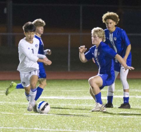 Isaac Abken (back left), Keagan Richardson (second from right) and Keshawn McElwain defend against Jarrell in a home district match on Tuesday. JEFF LOWE | DISPATCH RECORD