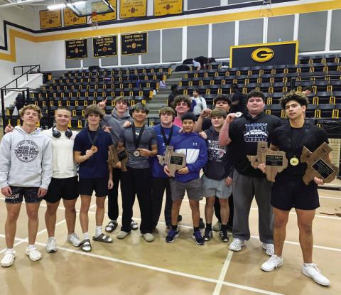 COURTESY PHOTO | LAMPASAS ATHLETICS FACEBOOK The boys’ powerlifting team shows off their plaques and medals from the regional meet last week.