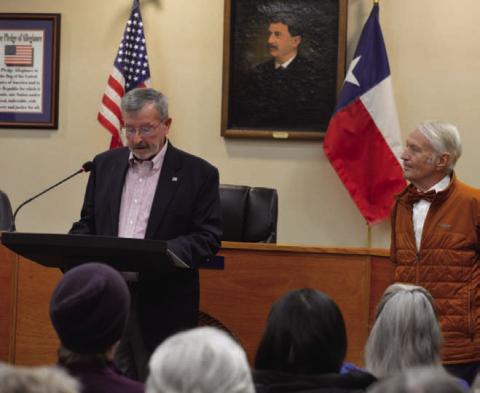 Municipal Court Judge Gene Isenhour, at left, speaks to those gathered in City Council Chambers for a ceremony Saturday morning to dedicate the municipal building in his name and Jack Clark’s. Clark, a CPA and financial consultant, stands to the right. ERICK MITCHELL | DISPATCH RECORD
