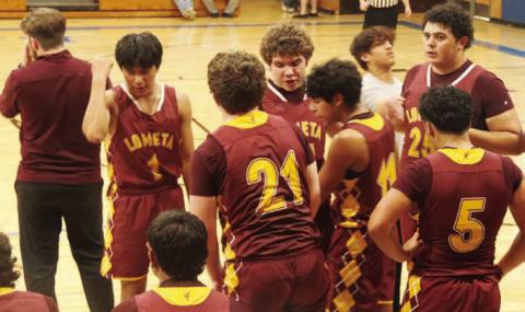 COURTESY PHOTO | AUSTIN MARTIN The Hornets gather around the bench during a road game this season.