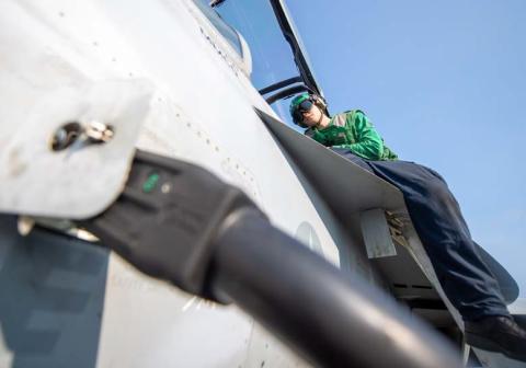 U.S. Navy photo by mass communication specialist seaman apprentice aaron Haro Gonzalez Logan Horn of Lampasas conducts maintenance work on an F/A-18E Super Hornet.