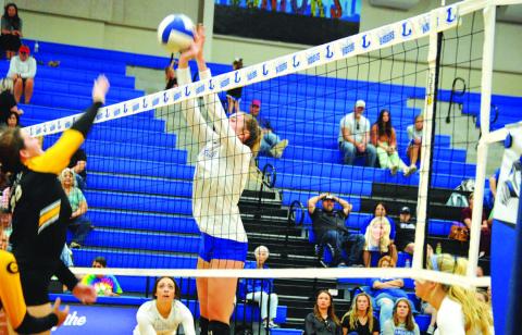 Breana Pelbath goes up and makes a block. She has led the team in blocks and kills all season. HUNTER KING | DISPATCH RECORD