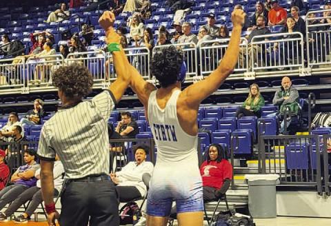 Kaiden Fernandez has his hand raised in victory during the Cy-Fair tournament. COURTESY PHOTO