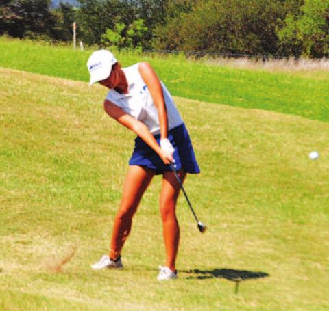 Shaylee Wolfe makes contact with a pitch shot during the state golf tournament on Tuesday. HUNTER KING | DISPATCH RECORD
