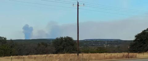 Smoke is seen on the horizon last week in rural Lampasas County. DISPATCH RECORD PHOTO