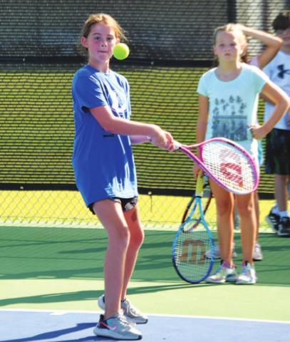 Aleighssa Donker prepares to hit a backhand shot back to head coach Kenneth Peiser at tennis camp. HUNTER KING | DISPATCH RECORD