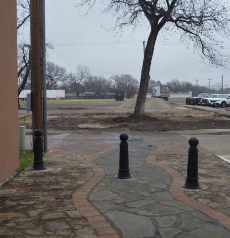 An empty space can be seen behind the Lampasas County Office Buildings, the former site of the pocket park. A future county-owned storage building will soon fill the space. ERICK MITCHELL | DISPATCH RECORD