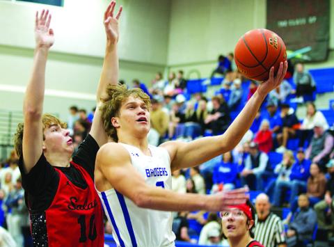 HUNTER KING | DISPATCH RECORD Haegan Oncken goes up to finish through contact from a Salado defender.