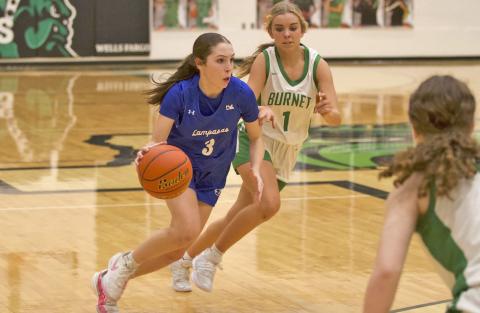 Kase Bumpus dribbles past a Burnet defender during the Lady Badgers’ district victory on Friday. HUNTER KING | DISPATCH RECORD