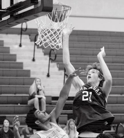 Kaeden Crawford (21) led Lampasas with 40 points over two games on Thursday. He is shown going for a basket against Lometa Hornet Dyllen Workmon. JEFF LOWE | DISPATCH RECORD