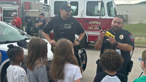 School Resource Officer Carlos Rodriguez, at right, demonstrates some of his law enforcement equipment to interested students. Courtesy photo
