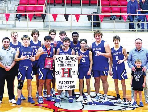 The Badgers pose with their trophy and banner as champions of the Hamilton varsity tournament. COURTESY PHOTO