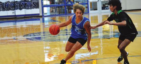 Haegen Oncken drives past a Burnet defender to the basket during Tuesday’s summer league game. HUNTER KING | DISPATCH RECORD