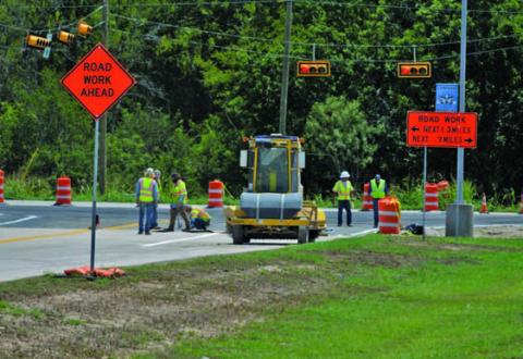 TxDOT contractors work to restripe the Lampasas High School entrance on Friday afternoon. ERICK MITCHELL | DISPATCH RECORD