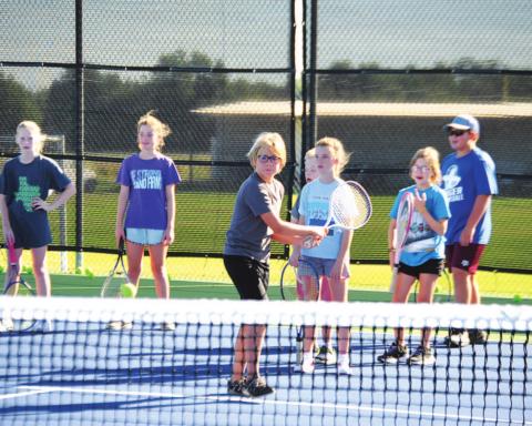 Jack Allison works on his backhand during tennis camp Tuesday morning. HUNTER KING | DISPATCH RECORD