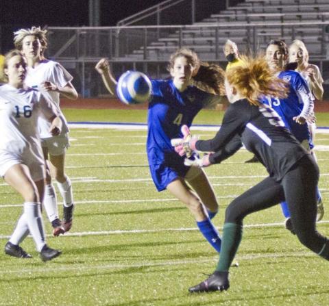Nyla Long (4) and Hailey Colbath (13) follow a shot toward the Academy goal in a close district loss on Friday. JEFF LOWE | DISPATCH RECORD