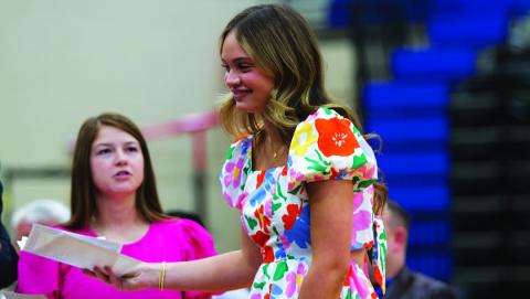Morgan Bobo receives her award at Wednesday night’s basketball banquet in the high school gym. HUNTER KING | DISPATCH RECORD