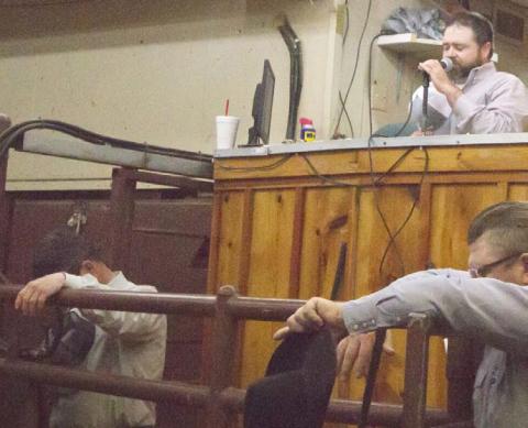 Lampasas Cattle Auction owner Andy Baumeister, at back right, prays before starting a Wednesday sale in March 2020, when COVID shutdowns closed many businesses. He has had ownership of the auction business since 2019. FILE PHOTO