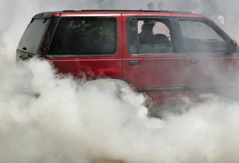 Smoke from the burnout competition is thick enough to obscure the cars competing. JOSEPH NEUENSCHWANDER | DISPATCH RECORD