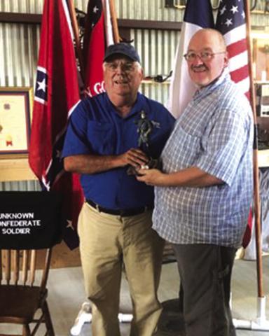 Sons of Confederate Veterans Camp Commander Michael Oliver, at right, presents the first-place trophy, a statue of Robert E. Lee, to John Anderson, winner of the Black Powder Turkey Shoot held Oct. 5. COURTESY PHOTO