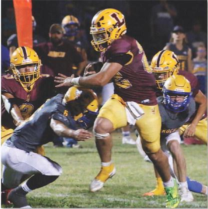Lukas Smailus-Cruz rumbles through two Rochelle defenders. Smailus-Cruz had 357 yards and five touchdowns in Friday’s contest. MASON HINES | DISPATCH RECORD