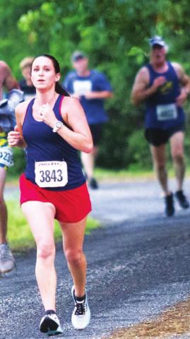 Holley Clifton of Lometa runs on the levee along Hancock Park Golf Course during last year’s race. FILE PHOTO