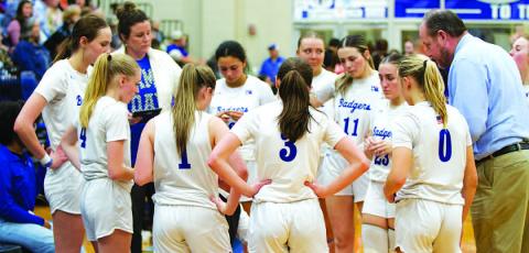 HUNTER KING | DISPATCH RECORD The Lady Badgers huddle around head coach Marcus Chapa during a timeout in the game against Jarrell on Tuesday.