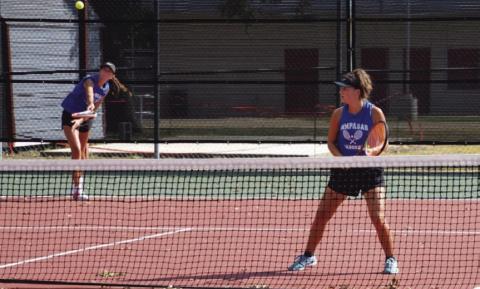 COURTESY PHOTO | KENNETH PEISER Chesley Breuer serves as Caroline White watches during a doubles match last week.