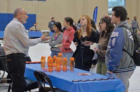 Erick Mitchell| Dispatch record Students speak with a representative from Whataburger during Wednesday’s job fair about possible career options.