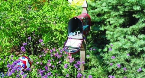 This old mailbox is filled with garden tools and is set in the garden for convenient access to make maintenance tasks easier to accomplish. COURTESY PHOTO | WWW.MELINDAMYERS.COM