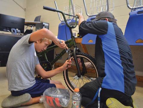erick Mitchell | dispatch record At left, Elias Vawter applies the finishing touches to his bike before taking it out for a ride during last week’s Wrenches to Wheels event at Lampasas Middle School.