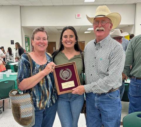 From left to right are Teri Gernentz, Shelby Hilbert and Lee Gernentz with the plaque honoring the Gernentzes for being named the Area V Outstanding Conservation Rancher. courtesy photo