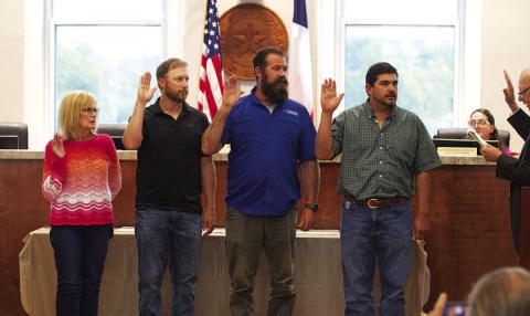 Taking the oath of office at Monday night’s meeting of the Lampasas City Council are newly elected members, from left, Dorothy Person and Edward Gold, and incumbents Charlie Pratus and Eric Hernandez who were re-elected along with Mayor Herb Pearce earlier this month. HUNTER KING | DISPATCH RECORD