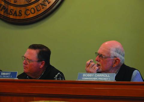 Commissioners Jamie Smart, left, and Bobby Carroll listen to residents’ input on battery energy storage systems or BESS projects in the county. Smart recommended seeking legal advice on how the county might prevent or regulate these developments. ERICK MITCHELL | DISPATCH RECORD