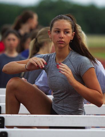 HUNTER KING | DISPATCH RECORD Landry White works on flexibility in the hurdles.