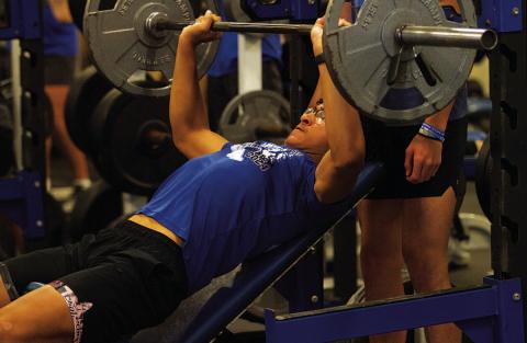 Ty Johnson lifts during incline bench press at the first day of SWAT on Monday. HUNTER KING | DISPATCH RECORD