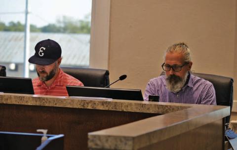Economic Development Corp. board members Fin Erwin, left, and Michael Gill read through materials in their meeting packets. Wednesday’s session was the EDC’s first after the appointment of a new board. ERICK MITCHELL | DISPATCH RECORD