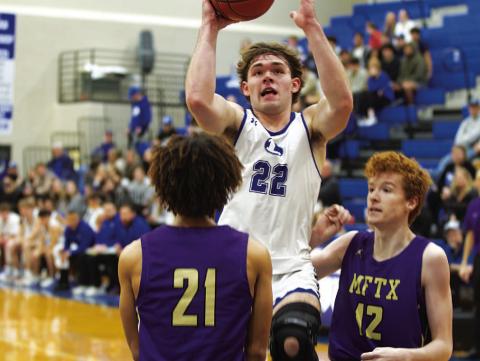 Carter Johnson rises up over a Marble Falls defender for two points in last Thursday’s game. HUNTER KING | DISPATCH RECORD