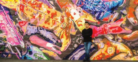 Lampasas High School 2021 graduate Xavier Trinidad is seen in front of the "Boot Roundup" mural at 411 S. Western St., as photographed by Lori Triba/Blue Jean Creative Studio. ©2021 BLUE JEAN CREATIVE STUDIO | COURTESY PHOTO