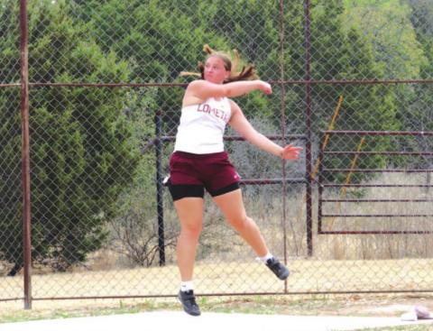 Sierra Tower follows through on a discus throw during the district meet earlier this season. FILE PHOTO