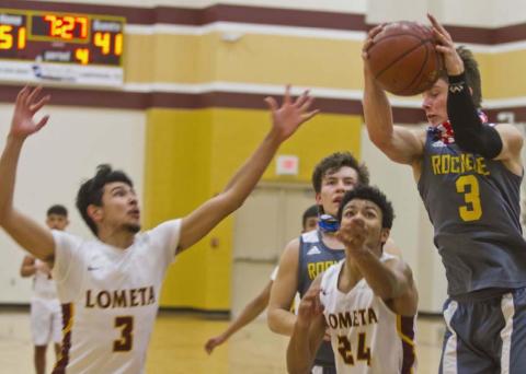 Alonso Caso (3) and Dyllen Workmon (24) swarm a Rochelle Hornet player during Lometa’s 15-0 run in the second half on Friday. JEFF LOWE | DISPATCH RECORD