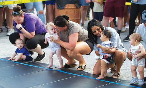 Mothers provide words of encouragement to their little ones before they take on the grueling Diaper Derby event. hunter king | dispatch record