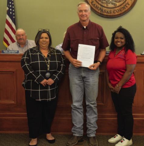 County Judge Randy Hoyer holds a proclamation naming June as Elder Abuse Awareness Month. He is joined by Isabel Jones, left, and Mariah Douglas from the Texas Adult Protective Services agency after the Lampasas County Commissioners Court ratified the proclamation last week. ERICK MITCHELL | DISPATCH DISPATCH