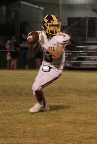 Alonso Caso looks downfield for a receiver during the Hornets’ win on Friday. JESSICA MALDONADO | DISPATCH RECORD