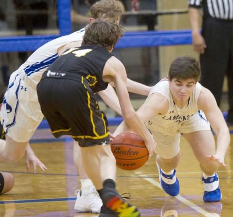 Dax Brookreson (right) dives for a steal. He had seven steals as Lampasas beat Gatesville 89-42 at home on Friday. JEFF LOWE | DISPATCH RECORD