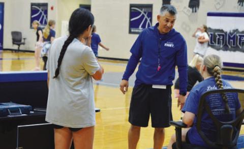 Marcus Chapa chats with a couple of his Lady Badgers at a camp last week. ERICK MITCHELL | DISPATCH RECORD