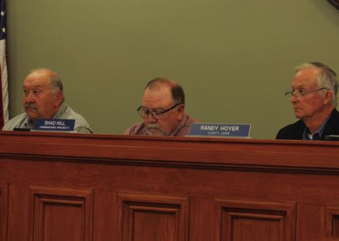 Commissioners Court members Mark Rainwater, left, Shad Hill and County Judge Randy Hoyer listen to testimony provided at Monday’s meeting. After hearing concerns from citizens about the proposed 765-kV transmission line that is projected to cross the county, commissioners directed Hoyer to file a protect with the Public Utility Commission. ERICK MITCHELL | DISPATCH RECORD